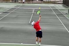 Senior, Ethan Tyson delivers a hot serve to his region opponent.