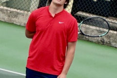 Carter McDaniel waits for his opponent to retrieve a ball before serving