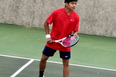 Alex Molina looks across the tennis complex during a match