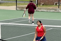 Senior, Abby Tacbianan speaks to her teammate during a doubles match against Heard County